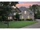Charming front exterior of a two-story brick home with manicured landscaping and a lush green lawn at 219 Deer Park Trl, Canton, GA 30114