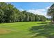 Scenic view of a well-maintained golf course with lush green grass and mature trees at 219 Deer Park Trl, Canton, GA 30114