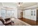 Well lit living room with leather sofa, rug and built in wall unit and large windows at 219 Deer Park Trl, Canton, GA 30114