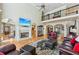 Inviting living room with a fireplace, hardwood floors, and a view of the second-story balcony at 219 Deer Park Trl, Canton, GA 30114