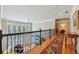 Upstairs loft overlooking living room, with hardwood floors, black iron railing, and lots of windows at 219 Deer Park Trl, Canton, GA 30114