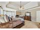 Large main bedroom features a tray ceiling, fireplace, dresser, and carpeted floors at 219 Deer Park Trl, Canton, GA 30114