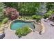 Aerial view of the backyard pool and outdoor fireplace area, surrounded by trees at 219 Deer Park Trl, Canton, GA 30114