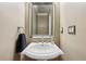 Modern powder room featuring a pedestal sink, elegant mirror, and neutral decor at 219 Deer Park Trl, Canton, GA 30114