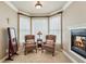 Bright sitting area features a fireplace, accent chairs, and large windows offering natural light at 219 Deer Park Trl, Canton, GA 30114