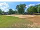 Outdoor sand volleyball court surrounded by lush green trees and manicured lawn at 219 Deer Park Trl, Canton, GA 30114