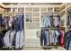 Organized walk-in closet with shelving for shoes, drawers, and hanging racks for clothing at 219 Deer Park Trl, Canton, GA 30114