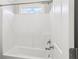 Bathroom with an enclosed shower/tub combo and a small window for natural light at 266 Hanover Dr, Villa Rica, GA 30180