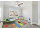 Cozy bedroom features ceiling fan, large window, and playful decor; ideal for Gathering and children at 266 Hanover Dr, Villa Rica, GA 30180