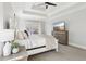 Bright bedroom with a tray ceiling, ceiling fan, TV, and bedside lamp at 266 Hanover Dr, Villa Rica, GA 30180