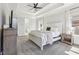 Bright bedroom with a tray ceiling, ceiling fan, bedside table, and TV at 266 Hanover Dr, Villa Rica, GA 30180