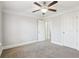 Well-lit bedroom features a ceiling fan, neutral walls, and two entryways, creating an airy feel at 266 Hanover Dr, Villa Rica, GA 30180
