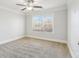 Bright bedroom with a ceiling fan and large window, providing natural light and comfort at 266 Hanover Dr, Villa Rica, GA 30180