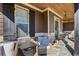 Cozy front porch with stone accents, wood pillars, and comfortable seating for outdoor relaxation at 266 Hanover Dr, Villa Rica, GA 30180