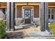 Charming front porch with decorative columns, stone accents, and a welcoming entrance with a stylish door at 266 Hanover Dr, Villa Rica, GA 30180