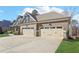 The home features a spacious three-car garage with convenient driveway access and well maintained landscaping at 266 Hanover Dr, Villa Rica, GA 30180