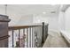 Upstairs hallway with wrought iron railing offering views of the main floor below at 266 Hanover Dr, Villa Rica, GA 30180