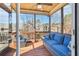 Inviting screened porch featuring wood floors, ceiling fan, comfortable seating, and scenic backyard views at 266 Hanover Dr, Villa Rica, GA 30180