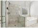 Bathroom with glass-enclosed shower and a luxurious soaking tub, featuring neutral-toned tile at 266 Hanover Dr, Villa Rica, GA 30180