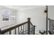 Elegant staircase with wrought iron railings and a view of the outdoors at 266 Hanover Dr, Villa Rica, GA 30180