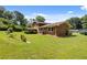 A beautifully kept lawn surrounds this classic brick home with mature trees and landscaping at 3082 Briarleaf Dr, Decatur, GA 30034