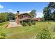 Charming brick home featuring a well-maintained lawn, lovely landscaping, and a screened-in porch at 3082 Briarleaf Dr, Decatur, GA 30034
