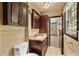 Cozy bathroom with dark wood cabinets, a tiled countertop, and modern fixtures at 3082 Briarleaf Dr, Decatur, GA 30034