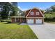 Charming home with a manicured lawn, attached two-car garage and brick accents at 3082 Briarleaf Dr, Decatur, GA 30034