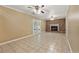 Spacious living room with tile flooring, brick fireplace, and double glass doors to the backyard at 3082 Briarleaf Dr, Decatur, GA 30034