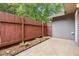A cozy back patio with a small planting bed and a wooden fence for privacy at 4908 Willow Lane Ln, Austell, GA 30106