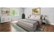 Well-lit bedroom with light walls, hard wood floors, and modern decor and furnishings at 4908 Willow Lane Ln, Austell, GA 30106
