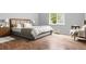 Bedroom featuring wood-look flooring, neutral walls, and bright windows at 4908 Willow Lane Ln, Austell, GA 30106