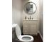 Stylish bathroom with modern vanity, vessel sink, and a round mirror above at 1062 Lena Nw St, Atlanta, GA 30314