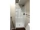 Modern shower with a black shower head, a built-in shelf and glass doors at 1062 Lena Nw St, Atlanta, GA 30314