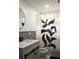 Updated bathroom with vanity, stylish shower curtain and plenty of natural light at 1062 Lena Nw St, Atlanta, GA 30314