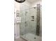 Modern shower with glass doors, tiled walls, and a convenient towel rack at 1062 Lena Nw St, Atlanta, GA 30314
