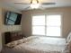 Cozy bedroom with a large window, ceiling fan, and dresser for storage at 1062 Lena Nw St, Atlanta, GA 30314