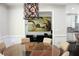 Elegant dining room featuring a stylish light fixture and a view of an office space with a large painting at 1062 Lena Nw St, Atlanta, GA 30314