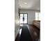 Inviting entryway with hardwood floors, a modern front door, and a glimpse of a cozy living area at 1062 Lena Nw St, Atlanta, GA 30314