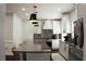 Gourmet kitchen featuring stainless steel appliances, a center island with seating, and ample storage space at 1062 Lena Nw St, Atlanta, GA 30314