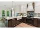 Modern kitchen boasting custom cabinets, marble countertops, updated appliances, and an apron sink at 1667 Willow Way, Woodstock, GA 30188