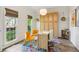 Bright home office with built-in storage and a whimsical, colorful area rug at 1667 Willow Way, Woodstock, GA 30188
