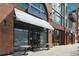 Storefront exterior featuring brick and wood facade with awning and street-side tables at 1667 Willow Way, Woodstock, GA 30188