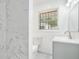 Updated bathroom featuring modern vanity, tiled shower, and window for natural light, creating a refreshing space at 2403 Tiffany Pl, Decatur, GA 30035