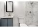 Modern bathroom with white marble tile shower and a vanity with a dark framed mirror at 2403 Tiffany Pl, Decatur, GA 30035