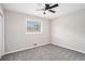 Bedroom with neutral carpet, modern ceiling fan, and large window for natural light, creating a serene atmosphere at 2403 Tiffany Pl, Decatur, GA 30035