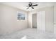 Bedroom with large window, overhead fan and generous closet space with a neutral color palette for a calming retreat at 2403 Tiffany Pl, Decatur, GA 30035