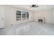 Bright living room with tile flooring, a decorative fireplace, and large windows offering a scenic view at 2403 Tiffany Pl, Decatur, GA 30035