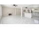 Open-concept living space with tile flooring, a fireplace, and a modern kitchen featuring granite countertops at 2403 Tiffany Pl, Decatur, GA 30035
