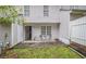 Private backyard featuring small patio, door to home, and green lawn at 338 Saratoga Pl, Riverdale, GA 30296